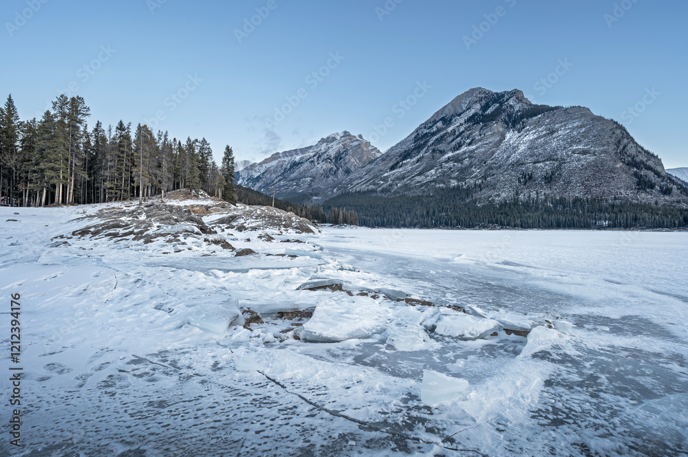 Ice on the rocky shore of frozen Lake Minnewanka in Banff National Park, Alberta, Canada