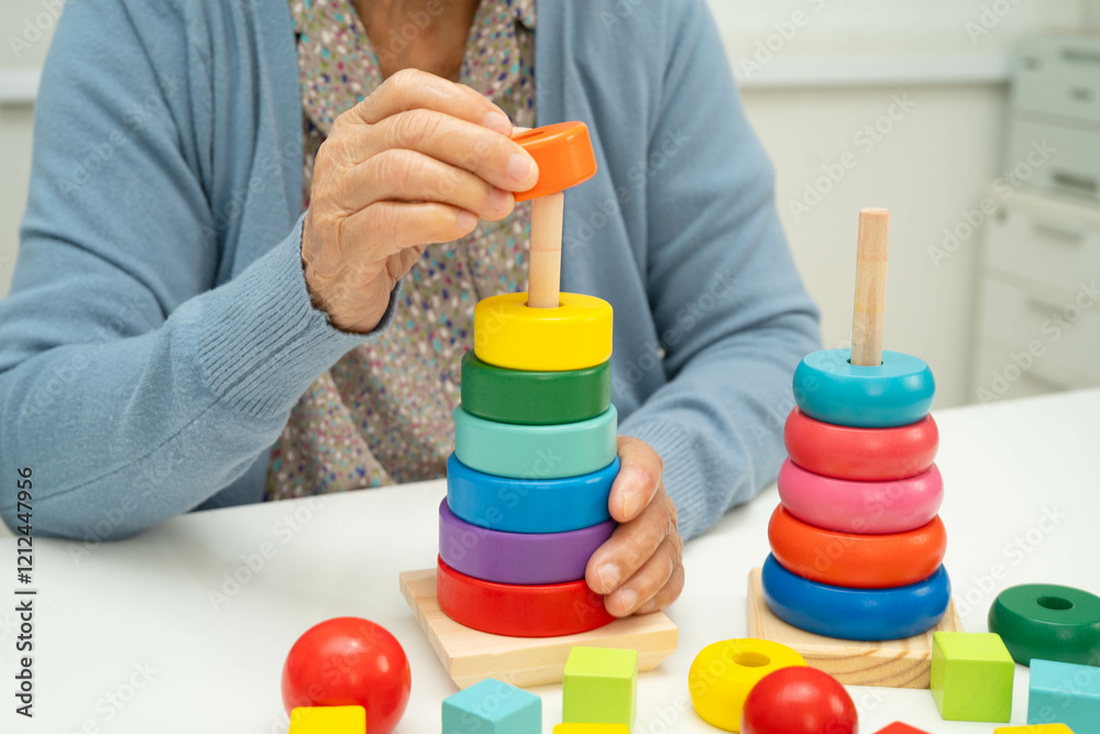 Asian elderly woman playing enhancing skill board game. Asian elderly woman playing enhancing skill board game.