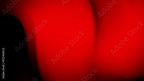 Abstract gradient of red and black hues creating a dynamic, fluid background.