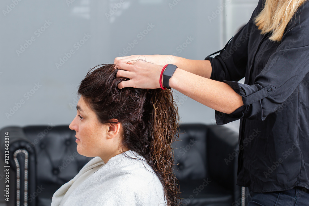Hairstylist massages head and scalp for a young female client Hairstylist massages head and scalp for a young female client