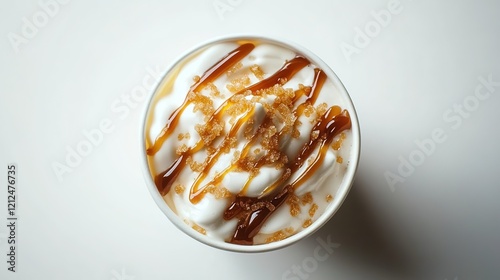 Top view of a milkshake with caramel drizzle and cream on a white background, product photography, food photography. A delicious-looking cup of coffee or latte,