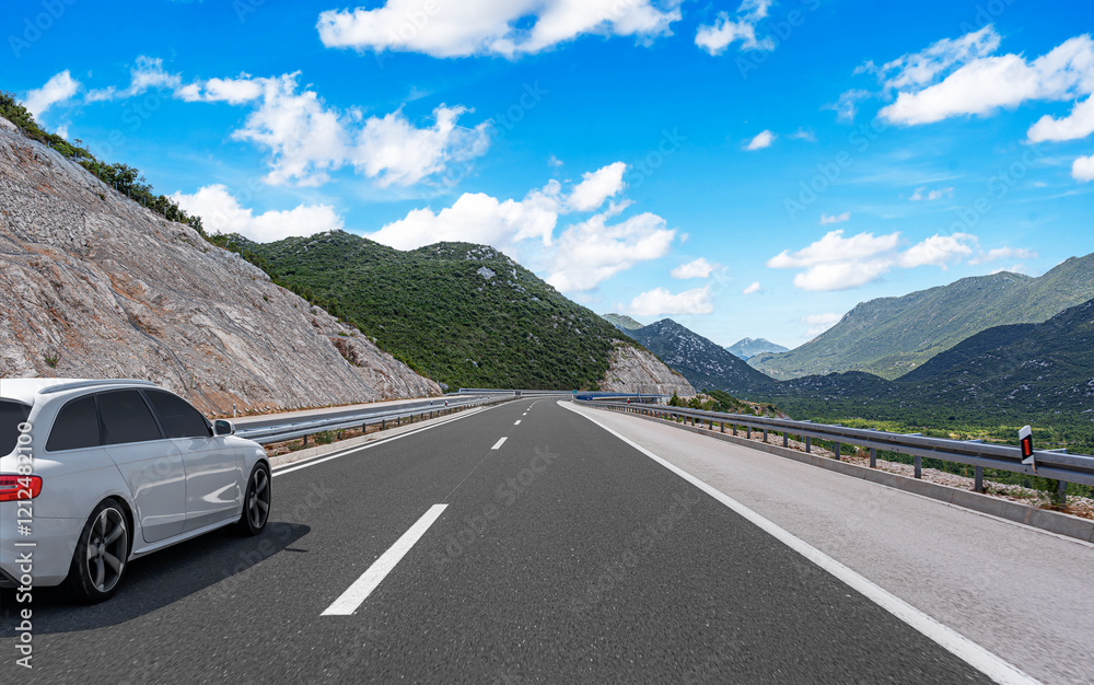 The car is driving along the highway surrounded by picturesque nature.