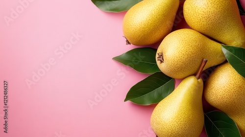 A lovely composition of ripe pears embellished with fresh green leaves set against a soft pink background, offering a rich and inviting visual appeal. photo