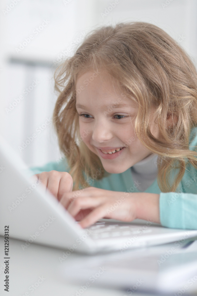 Cute and happy little girl children using laptop computer Cute and happy little girl children using laptop computer