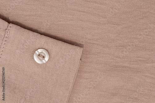 Close-up of brown shirt sleeve with buttons. brown men's shirt