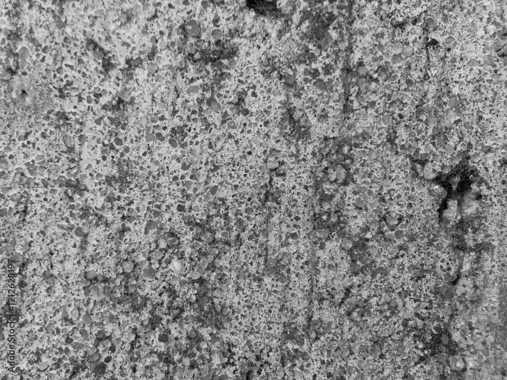 A grey and white wall with a lot of holes and cracks A grey and white wall with a lot of holes and cracks