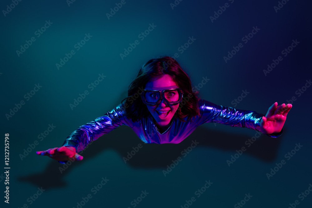 Φωτογραφία Photo of gorgeous young girl glasses flying air wear shiny dress neon light dark