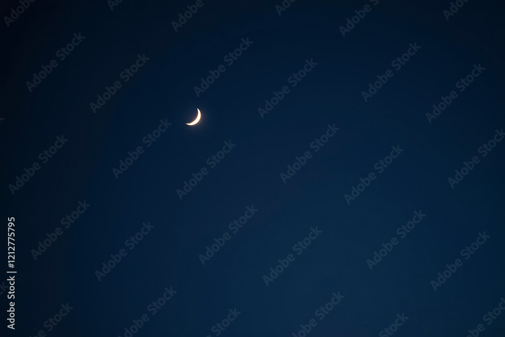 Minimalist glowing crescent moon in the night sky with space for quotes or messages Minimalist glowing crescent moon in the night sky with space for quotes or messages