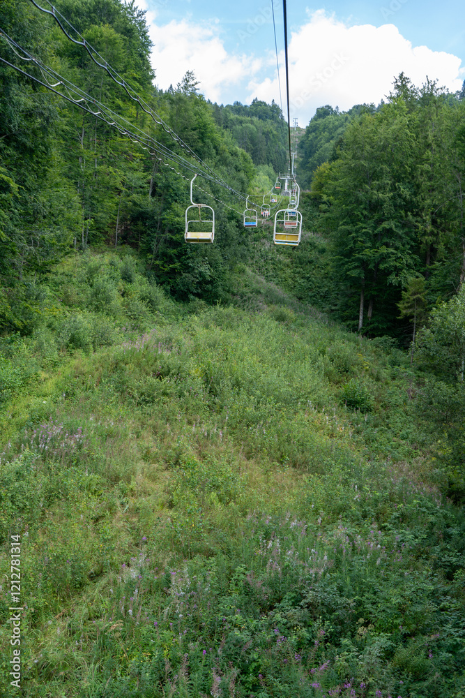 Cableway to top of Carpathian Mountain peak. Hills green forest. Nature summer travel Cableway to top of Carpathian Mountain peak. Hills green forest. Nature summer travel