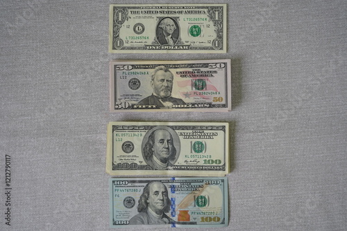 Us dollar banknotes forming an ascending sequence on grey background