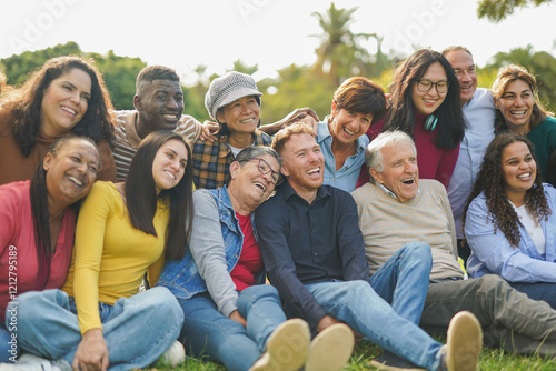 Crowd of happy multiracial people hugging each other outdoor while smiling in front of camera - Multi generational community and diversity concept - Focus on center man face