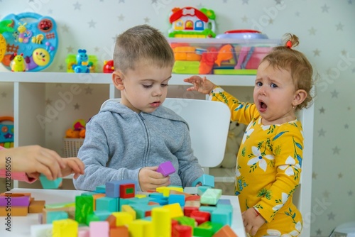 Children playing with toys in the room. Selective focus