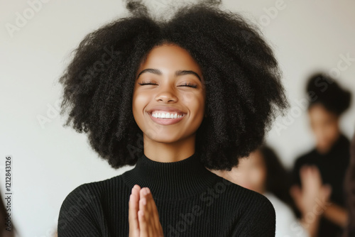 Young African American Woman Meditating and Smiling Blissfully in a Tranquil Setting photo