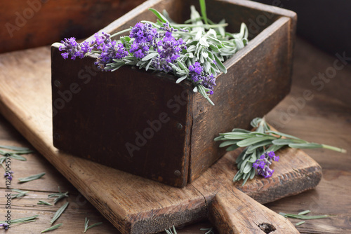 Lavender herb in a woooden vintahe box with flowers on wooden rustic background, closeup, sleep and skin healing plant, natural medicine and naturopathy concept photo