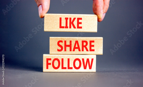 Like share follow symbol. Concept words Like Share Follow on beautiful wooden blocks. Beautiful grey background. Businessman hand. Business like share follow concept. Copy space.