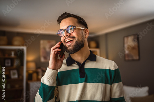 Fotografie portrait of adult man stand and talk on mobile phone at home