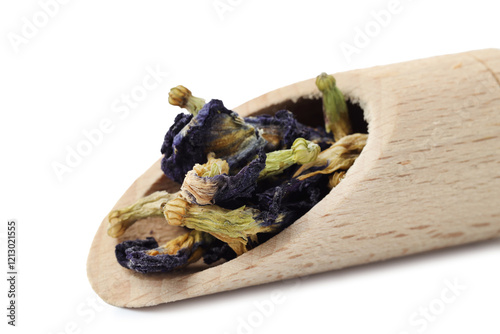 Butterfly pea flower tea. Dry Clitoria ternatea petals in scoop isolated on white photo