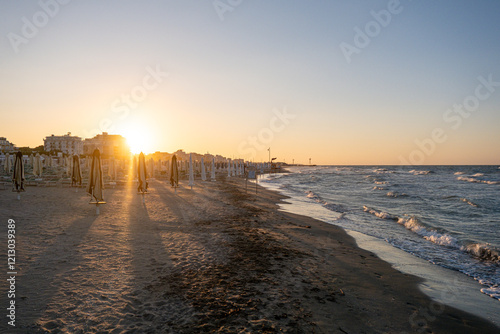 dawn on the beach of Cesenatico with sun and gentle waves. High quality photo
