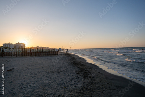 dawn on the beach of Cesenatico with sun and gentle waves. High quality photo photo