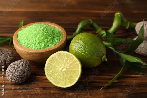 Photography Spa composition with fresh limes, sea salt, stones and bamboo on wooden table, c