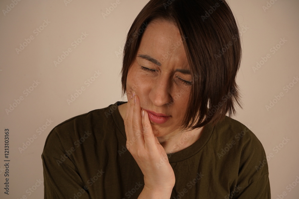 Very tired stressed young business woman standing near the wall. Holding a hand on the shock and feeling intense pain. After a sweet cake. Very tired stressed young business woman standing near the wall. Holding a hand on the shock and feeling intense pain. After a sweet cake.
