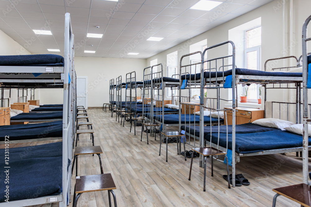 Fototapeta premium Empty dormitory room with bunk beds and wooden flooring