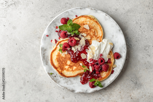 Obraz na plátně Homemade pancakes with yoghurt, berries and raspberry jam