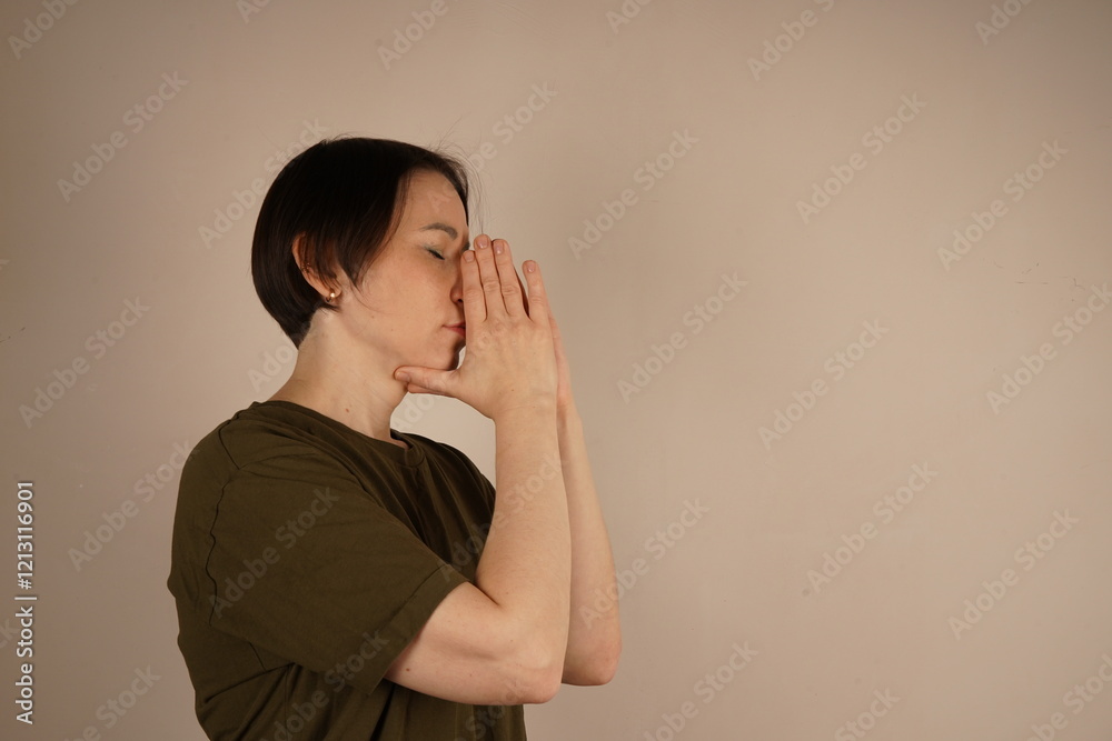 Woman praying hands with faith in religion and faith in God on gray studio background. Namaste or Namaskar hand gesture, pay respect, prayer position. Woman praying hands with faith in religion and faith in God on gray studio background. Namaste or Namaskar hand gesture, pay respect, prayer position.