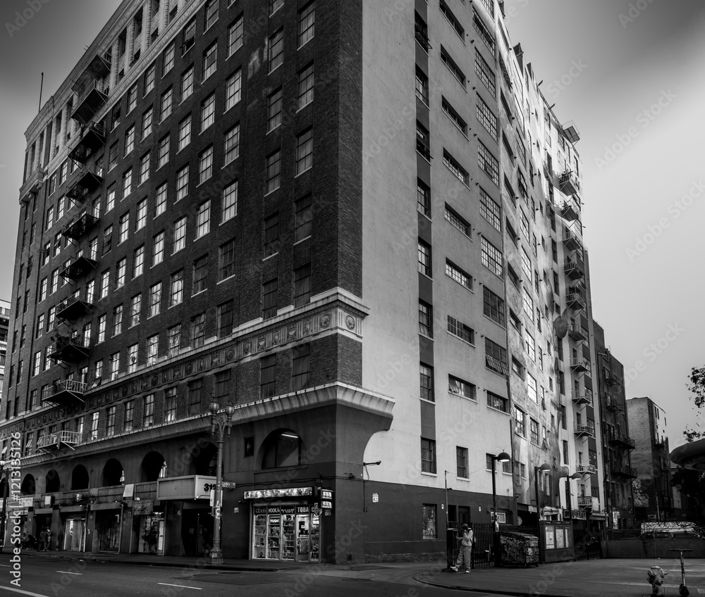 Black and white monochrome photo of vintage building in urban downtown cityscape setting