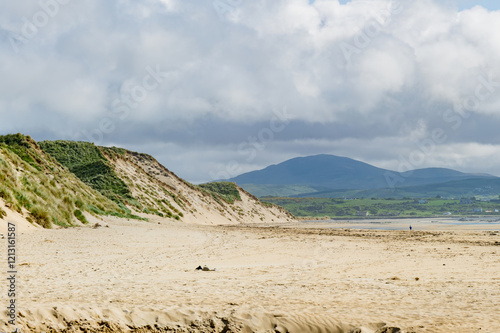 Five Finger Strand, one of the most famous beaches in Inishowen known for its pristine sand and rocky coastline with some of the highest sand dunes in Europe, county Donegal, Ireland. photo