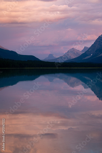 Sunset colours and reflections at the Waterfowl Upper Lake located just of Banff National Park’s Icefields Parkway.