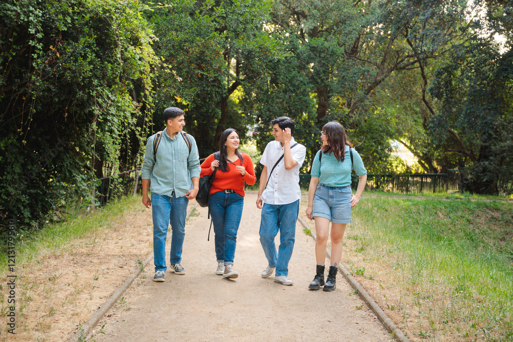 Fototapeta premium Group of four happy students with backpacks in the park