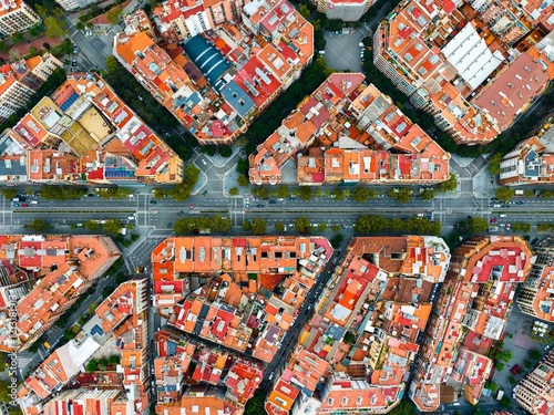 Exploring Barcelona's unique architecture and urban layout from above during a sunny day