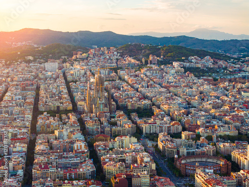 Vibrant sunset over Barcelona showcasing urban landscape and architecture from above