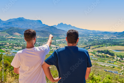 Obraz na płótnie Two tourists enjoying the view with Franschhoek Wine Valley in the background, Franschhoek, South Africa w salonie