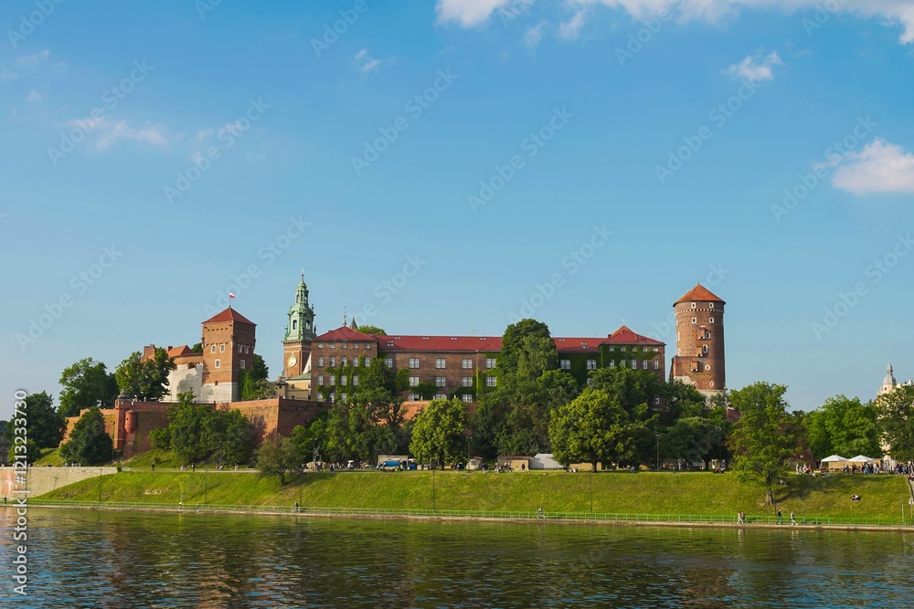 Explore the historic Wawel Castle in Krakow overlooking the Vistula River under a clear blue sky Explore the historic Wawel Castle in Krakow overlooking the Vistula River under a clear blue sky
