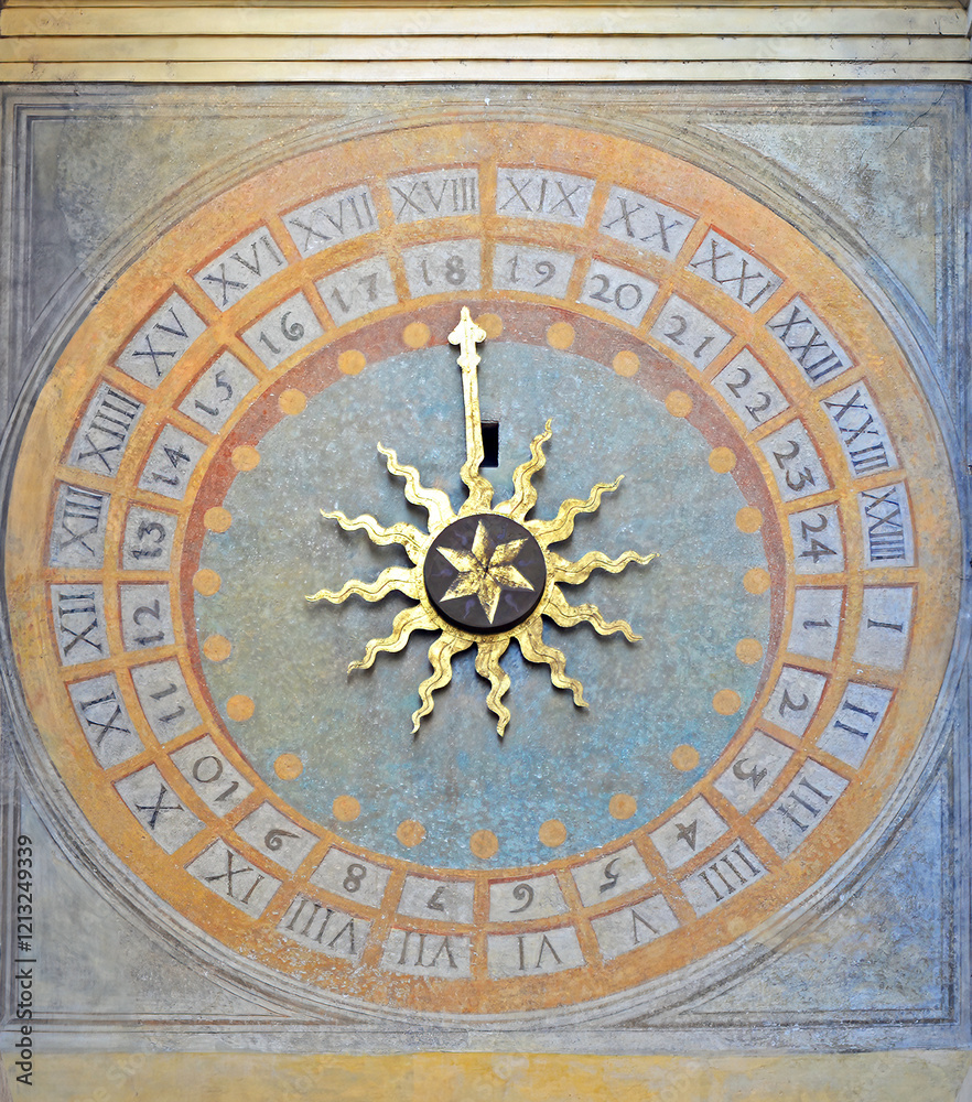 Clock on the backside of the Torre dell'orologio with golden sun in Brescia, Italy Clock on the backside of the Torre dell'orologio with golden sun in Brescia, Italy