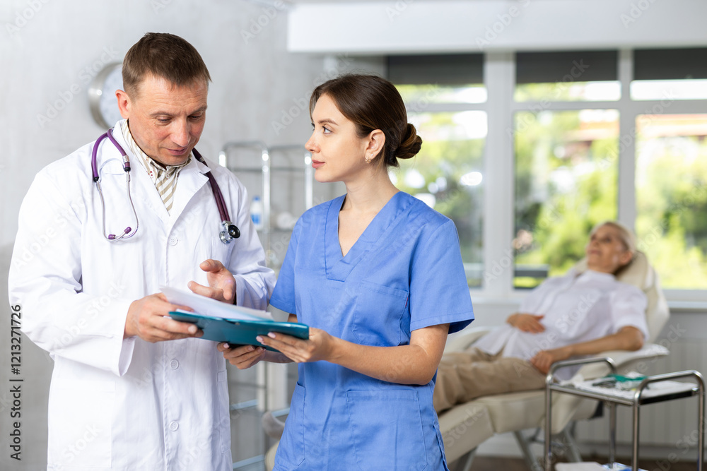 Fototapeta premium Two doctors are carefully examining the patient medical history