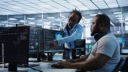 System administrator working with colleague in data center providing computing resources for different workloads. IT specialist talking with coworker while monitoring AI supercomputers, camera B