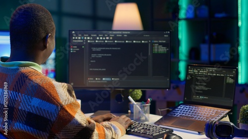Black software engineer writes complex binary code scripts on computer, cybersecurity. Teleworking IT specialist in home office using programming language to safeguard consumer data. Camera A.