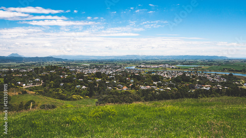 Aerial city town view whakatane new zealand blue sky green foliage trees vibrant summer day photo