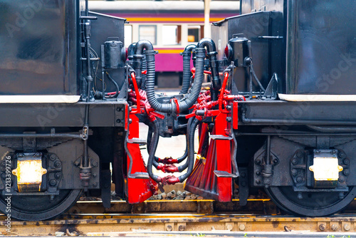 Chain coupler connecting freight wagons retro steam locomotives close up, large wagon buffers visible. photo