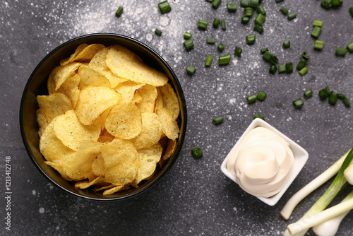 Crispy potato chips in blac...