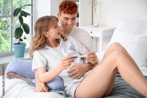 Happy young couple with pre...