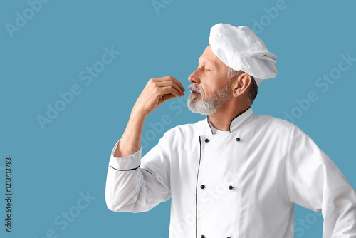 Mature chef gesturing on bl...