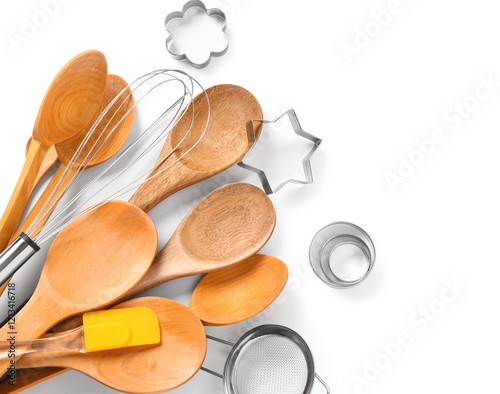 Wooden baking utensils and cookie cutters isolated on white background photo