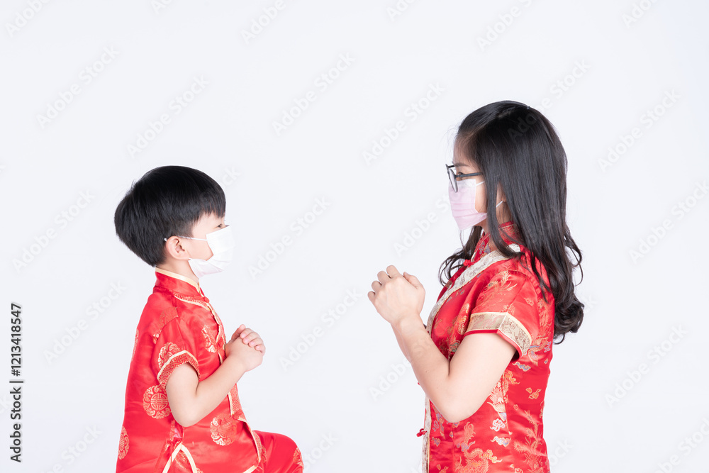 Mother and son in traditional Chinese attire wearing masks and exchanging greetings on a white background. Mother and son in traditional Chinese attire wearing masks and exchanging greetings on a white background.