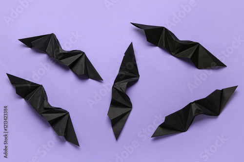 Black origami bats on purpl...