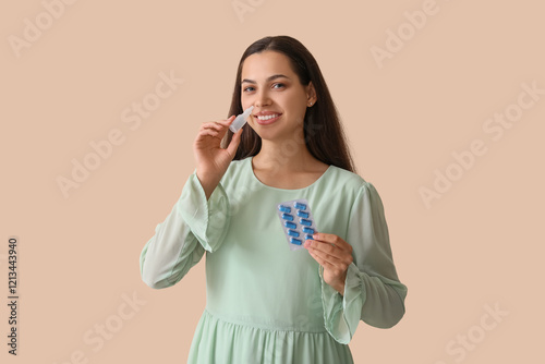 Young woman with nasal drop...