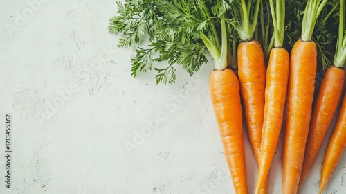 Shiny orange carrots with their leafy tops intact, lying gracefully on a white backdrop. Naturally appealing. photo